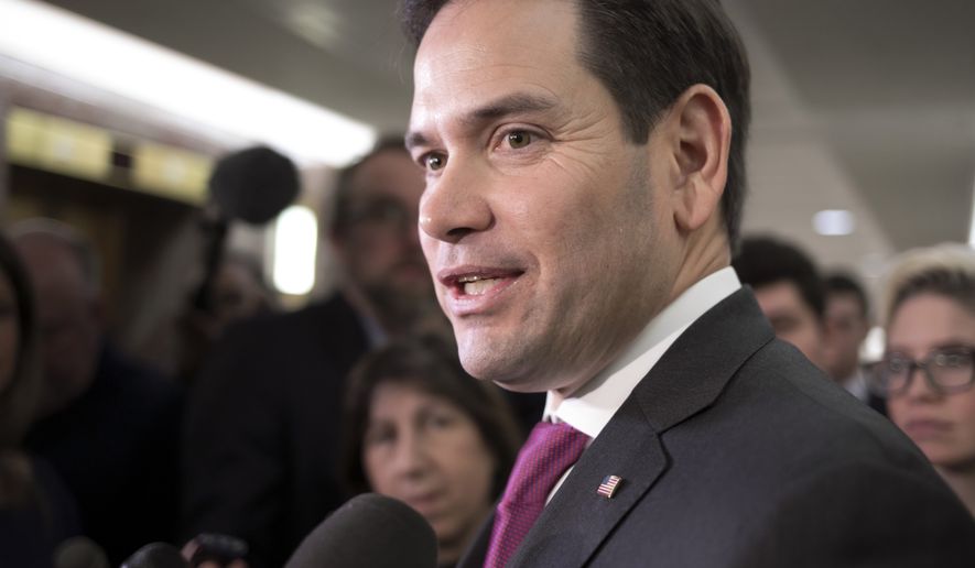 Sen. Marco Rubio, R-Fla., speaks with reporters as he leaves the office of Sen. Susan Collins, R-Maine, who is moderating bipartisan negotiations on immigration, at the Capitol in Washington, Thursday, Jan. 25, 2018. President Donald Trump has given Congress until March to come up with a plan to protect the nearly 700,000 young people who had been protected from deportation and given the right to work legally in the country under the Obama-era Deferred Action for Childhood Arrivals program, or DACA. Mr. Trump announced in 2017 he was ending DACA. (AP Photo/J. Scott Applewhite)