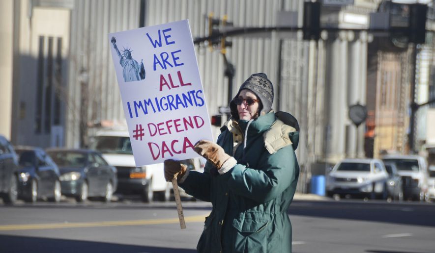 Jill Carlson, a member of Columbia County Indivisible, holds a sign expressing her views on the Deferred Action For Childhood Arrivals (DACA) while joining other protesters gathering outside of Congressman Louis Barletta&#x27;s local office located at the intersection of West Broad and South Church streets in Hazleton, Pa., Thursday, Jan. 25, 2018. (Ellen F. O&#x27;Connell/Hazelton Standard-Speaker via AP)