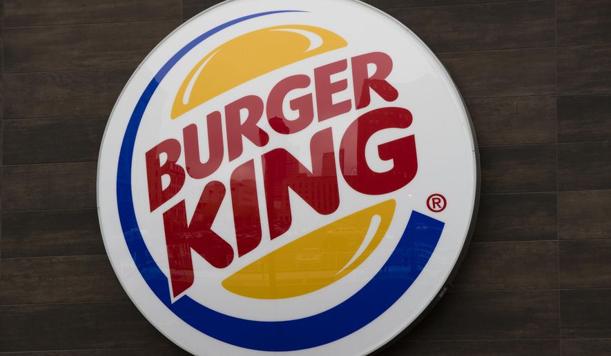 This Oct. 21, 2016, file photo shows a Burger King restaurant logo in Philadelphia. Burger King has delivered its own hot take on a regulatory showdown that has enflamed the U.S., with a flame-grilled Whopper. The new ad has become a sensation, with more than a million views and counting on YouTube. In the ad, customers are told they will be charged different prices for a Whopper, depending on how fast they want it. (AP Photo/Matt Rourke, File)