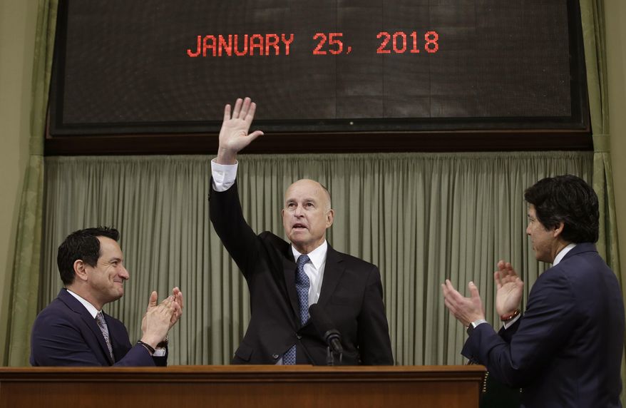 California Gov. Jerry Brown waves as he receives applause from Assembly Speaker Anthony Rendon, D-Lakewood, left, and Senate President Pro Tem Kevin de Leon, of Los Angeles before giving his annual State of the State speech before a joint session of the Legislature, Thursday, Jan. 25, 2018, in Sacramento, Calif. Brown delivered his 16th and final address as governor, having served two terms starting in 1975 and returning for two more in 2011. (AP Photo/Rich Pedroncelli)