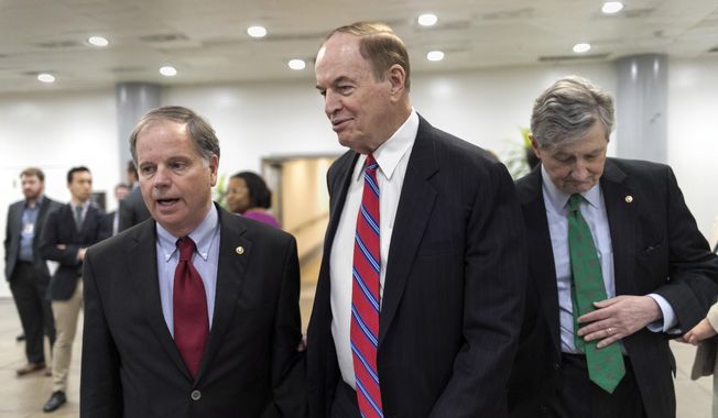 While Republicans tack priorities onto the spending bill, Senate Appropriations Committee Chairman Richard C. Shelby (center) warned, &quot;You don&#x27;t want to overload the truck.&quot; He is shown here with Sen. Doug Jones (left) Alabama Democrat, and Sen. John Kennedy, Louisiana Republican. (Associated Press/File)
