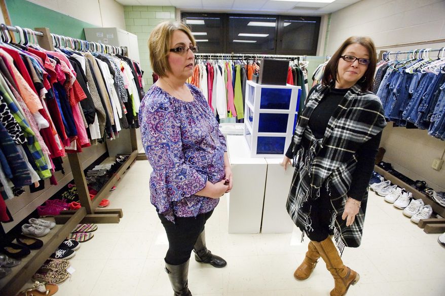 In this Jan. 4, 2018 photo, special education teacher Angel Warman, left, and Loretta Phillips, right, para-professional, talk about the clothing room at Charleston High School in Charleston, Ill. Two years ago, Warman realized some students weren't going to prom or other school dances because they didn't have the right attire. She began collecting formal wear, told other teachers about the effort and it "evolved" into more. The reaction was such that it went from having a small room for prom dresses and the like to CHS Principal Trevor Doughty allowing the use of an unused classroom for the clothing pantry. (Kevin Kilhoffer/Journal Gazette via AP)