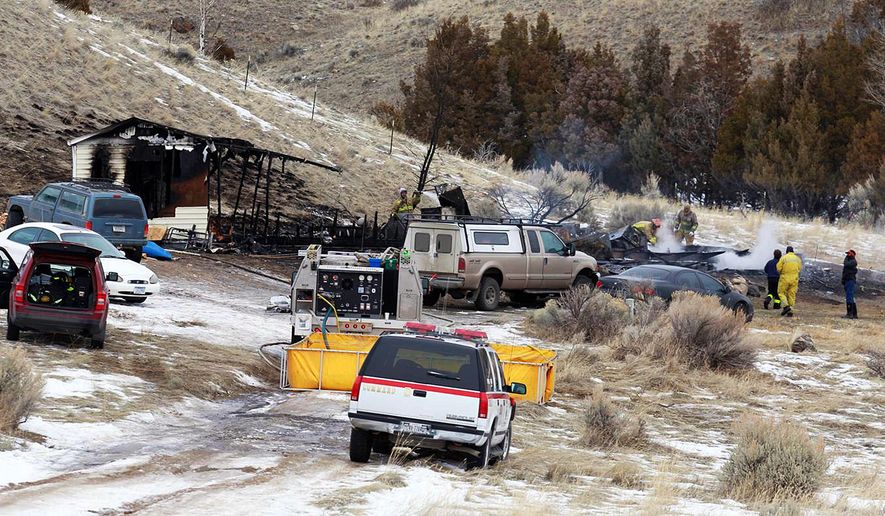 Emergency personnel work at the scene of a fatal fire in South Glastonbury, near Emigrant, Mont., Thursday, Jan. 25, 2018. The Park County sheriff's office says the fire was reported by neighbors just after 4 a.m. Thursday. The cause of the fire is under investigation. (Nate Howard/Livingston Enterprise via AP)