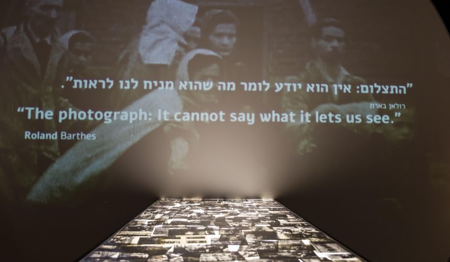 In this Wednesday, Jan. 24, 2018, photo, a part of the "Flashes of Memory" exhibition of the photos from the Holocaust is seen at at the Yad Vashem Holocaust memorial in Jerusalem. Israel’s Yad Vashem Holocaust memorial's latest exhibition explores the power of photography during World War II. (AP Photo/Tsafrir Abayov)
