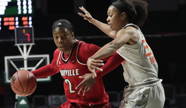 Louisville&#x27;s Myisha Hines-Allen (2) drives to the basket as Miami&#x27;s Erykah Davenport (30) defends during the first half of an NCAA college basketball game, Thursday, Jan. 25, 2018, in Coral Gables, Fla. (AP Photo/Lynne Sladky)