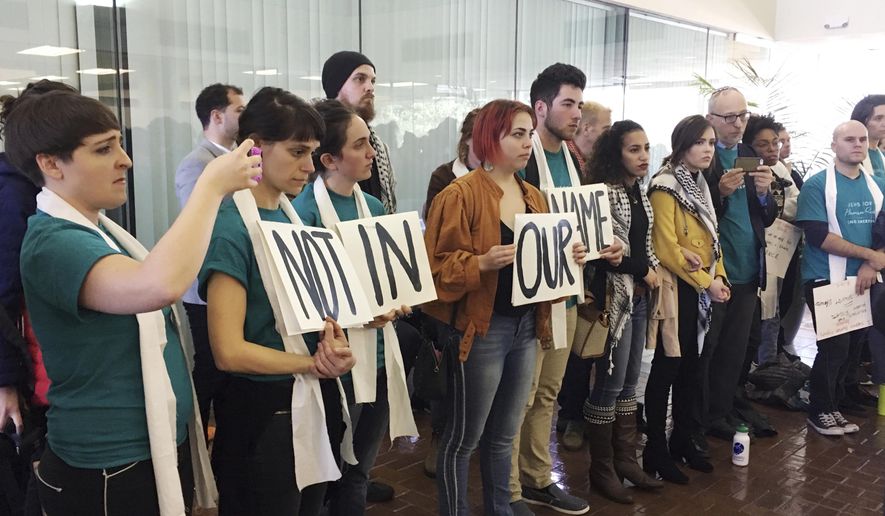 Demonstrators line up outside a meeting room protesting the New Orleans City Council vote rescinding a human rights resolution backed by Palestinian groups during a meeting in New Orleans, Thursday, Jan. 25, 2018. The Jan. 11 resolution encourages review of city investments or contracts involving businesses that violate human and civil rights. It mentions no nation, issue or business. But it's backed by a movement highly critical of Israel's policies toward the Palestinians. (AP Photo/Kevin McGill)
