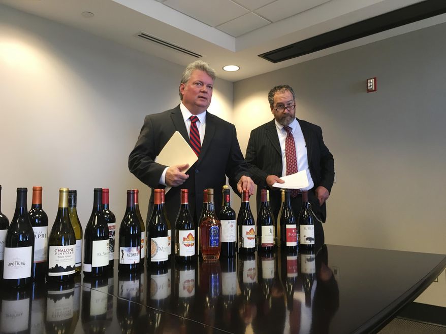 Mississippi Attorney General Jim Hood, left, and Revenue Commissioner Herb Frierson announce lawsuits against wine merchants illegally shipping wine into Mississippi on Thursday, Jan. 25, 2018, in Jackson, Miss. Hood said companies are ignoring the law against shipments to Mississippi and not checking ages of buyers. (AP Photo/Jeff Amy)