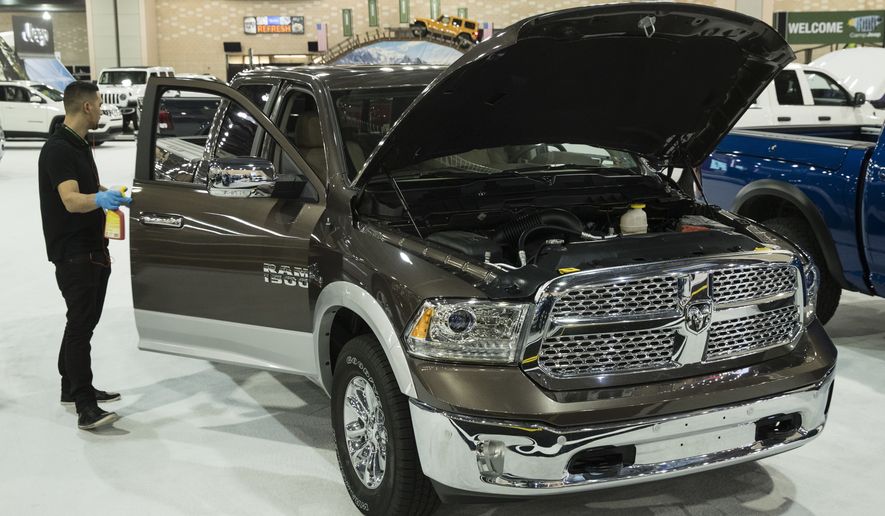 A worker cleans a Dodge Ram 1500 during a press preview of the Philadelphia Auto Show at the Pennsylvania Convention Center in Philadelphia, Friday, Jan. 26, 2018. The event is scheduled to run from Jan. 27 to Feb. 4. (AP Photo/Matt Rourke)