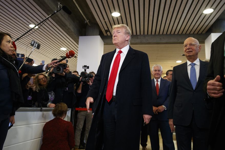 President Donald Trump talks with reporters as he arrives at the World Economic Forum, Friday, Jan. 26, 2018, in Davos. (AP Photo/Evan Vucci)