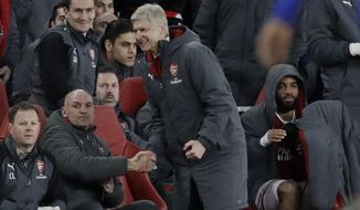 Arsenal&#x27;s French manager Arsene Wenger, celebrates at the end of the English League Cup semifinal second leg soccer match between Chelsea and Arsenal at the Emirates stadium in London, Wednesday, Jan.24, 2018. Arsenal won 2-1 and will play the final of the tournament. (AP Photo/Matt Dunham)