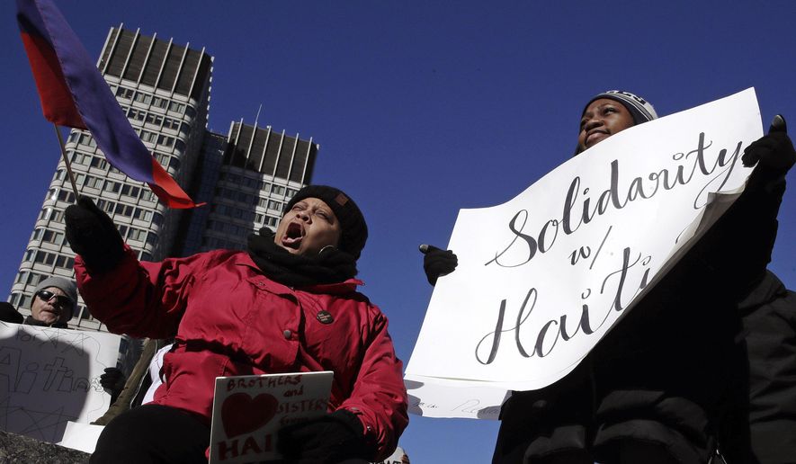 Haitian activists and immigrants protest on City Hall Plaza in Boston, Friday, Jan. 26, 2018. Haitian community leaders complained last week that the Trump administration's delays in re-registering those living in the U.S. legally through the Temporary Protected Status program would lead to job losses, travel problems and other issues for Haitians. (AP Photo/Charles Krupa)