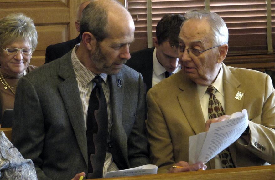 In this file photo taken March 21, 2017, Craig Neuenswander, front left, director of the Kansas Department of Education's school finance team, confers with Deputy Education Secretary Dale Dennis, right, during a meeting legislative committee meeting at the Statehouse in Topeka, Kan. Dennis has come under fire from some Republican lawmakers over an auditing questioning how he and his staff distribute some funds, but the State Board of Education has expressed its full support for him. (AP Photo/John Hanna).