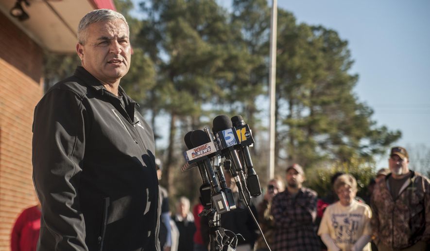 Concerned residents and relatives of missing child four-year-old Raul Johnson listen as Scotland County Sheriff Ralph Kersey updates the media on the status of the search for the boy near Laurinburg, N.C., Thursday, Jan. 25, 2018. Authorities in Scotland County say Raul Johnson left his home on Wednesday while his grandfather was babysitting him. The home is about 2,000 feet from the South Carolina line.Scotland County Sheriff Ralph Kersey told local news outlets that when Raul left his house, he was barefoot and dressed only in pajamas. (Paul Woolverton/The Fayetteville Observer via AP)