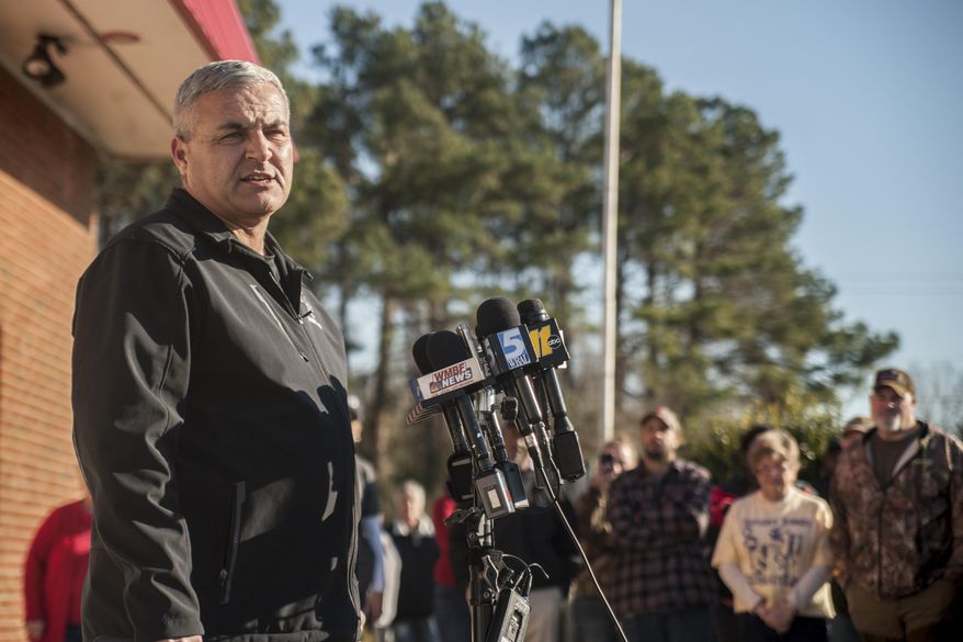 Concerned residents and relatives of missing child four-year-old Raul Johnson listen as Scotland County Sheriff Ralph Kersey updates the media on the status of the search for the boy near Laurinburg, N.C., Thursday, Jan. 25, 2018. Authorities in Scotland County say Raul Johnson left his home on Wednesday while his grandfather was babysitting him. The home is about 2,000 feet from the South Carolina line.Scotland County Sheriff Ralph Kersey told local news outlets that when Raul left his house, he was barefoot and dressed only in pajamas. (Paul Woolverton/The Fayetteville Observer via AP)