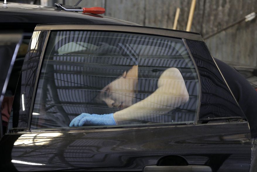 FILE - In this May 12, 2016 file photo, Jeremiah Munavu, lead technician at Auto Glass Now, installs a new window on a car in a garage in San Francisco. Across the street from San Francisco's main jail, business is booming at Auto Glass Now where annoyed motorists line up daily to get broken side windows in their vehicles replaced. Data show San Francisco police have made arrests in 13 of the more than 81,000 cases of auto break-ins reported online in the past seven years. The San Francisco Chronicle reports Friday, Jan 26, 2018, an average of 85 auto break-ins are reported in San Francisco each a day. (AP Photo/Jeff Chiu, File)
