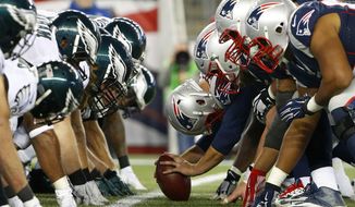 FILE - In this Dec. 6, 2015, file photo, the New England Patriots, right, and the Philadelphia Eagle get set for the snap at the line of scrimmage during an NFL football game at Gillette Stadium in Foxborough, Mass. The two teams are set to meet in Super Bowl 52 on Sunday, Feb. 4, 2018, in Minneapolis. (Winslow Townson/AP Images for Panini via AP, File)