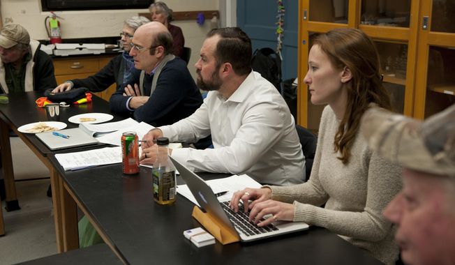 In this photo taken Jan. 10, 2018, from right at center, researchers Katie Whipkey, Ryan Brown and Rob Lempert gather comments at the Sitka Sound Science Center in Sitka, Alaska. While researching landslide preparedness in Sitka, RAND Corporation investigators have found a shared concern among Sitkans about the future of housing availability in the community. Researchers Brown, Lempert and Whipkey made their second trip to Sitka under a yearlong planning grant from the National Science Foundation&#x27;s &amp;quot;Smart and Connected Communities Program.&amp;quot; (James Poulson/Daily Sitka Sentinel via AP)