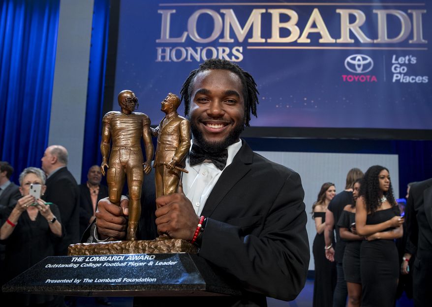 Stanford running back Bryce Love poses for photos with the Lombardi Award trophy at the Lone Star College Cy Fair on Saturday, Jan. 27, 2018, in Cypress, Texas. (Brett Coomer/Houston Chronicle via AP)