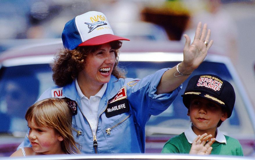 FILE - In this 1985 file photo, high school teacher Christa McAuliffe rides with her children Caroline, left, and Scott during a parade down Main Street in Concord, N.H. New Hampshire Gov. Chris Sununu is proclaiming a day in honor of McAuliffe who died in the NASA Challenger disaster decades ago. Sununu said Sunday, Jan. 28 will be known as "Christa McAuliffe Day" in honor of the woman selected to become the first educator in space. (AP Photo/Jim Cole, File)