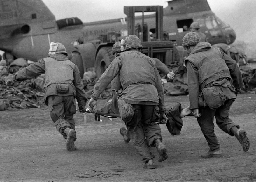 Days after these U.S. Marines at Khe Sanh carried a wounded comrade to be evacuated, North Vietnamese troops blocked a rescue platoon. (Associated Press/File)