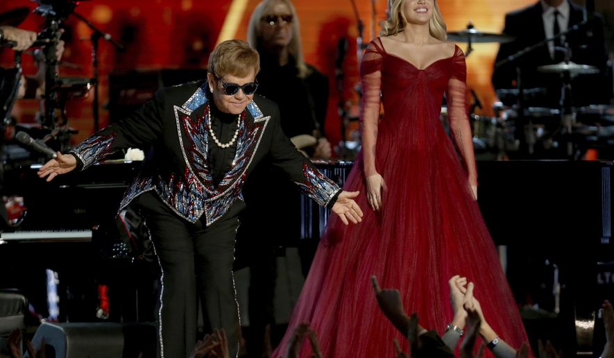 Elton John, left, and Miley Cyrus appear after a performance of "Tiny Dancer" at the 60th annual Grammy Awards at Madison Square Garden on Sunday, Jan. 28, 2018, in New York. (Photo by Matt Sayles/Invision/AP)