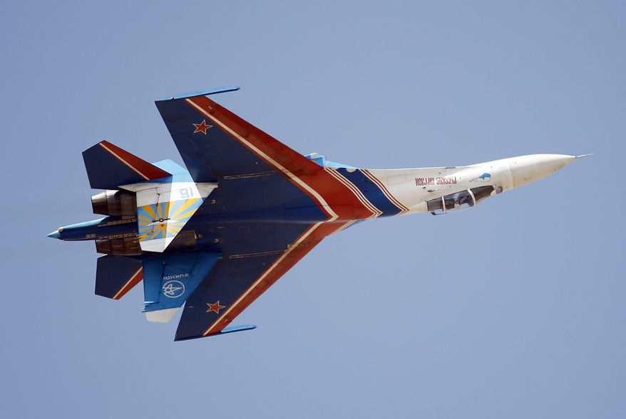 Russian air force air demonstration team, Russian Knights' Sukhoi Su-27 displays an inverted flight during the last day of the Aero India 2013 at Yelahanka air base in Bangalore, India, Sunday, Feb. 10, 2013. More than 600 aviation companies along with delegations from 78 countries took part in the five-day event. (AP Photo/Aijaz Rahi)
