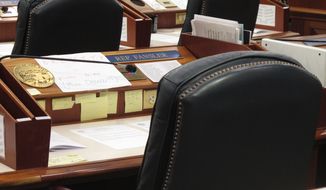 The desk of Alaska state Rep. Zach Fansler sits empty on the House floor on Monday, Jan. 29, 2018, in Juneau, Alaska. Attendance for the session was not mandatory. House Speaker Bryce Edgmon on Saturday requested Fansler&#39;s resignation after a report in the Juneau Empire in which a woman alleged that Fansler hit her during a night of drinking. Fansler&#39;s attorney has said there was no crime. (AP Photo/Becky Bohrer)