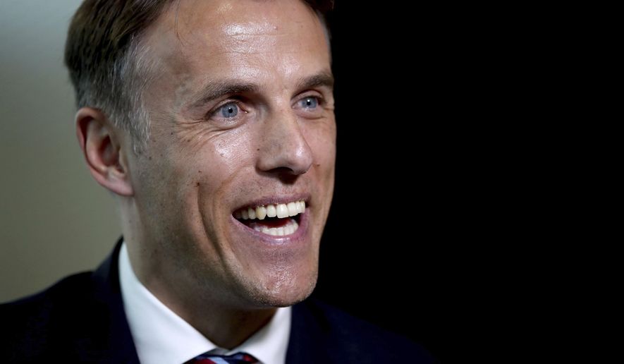 Newly appointed head coach for the England women&#39;s soccer team, Phil Neville speaks to the media during his official unveiling at St George&#39;s Park, in Burton, England, Monday, Jan. 29, 2018. (Nick Potts/PA via AP)