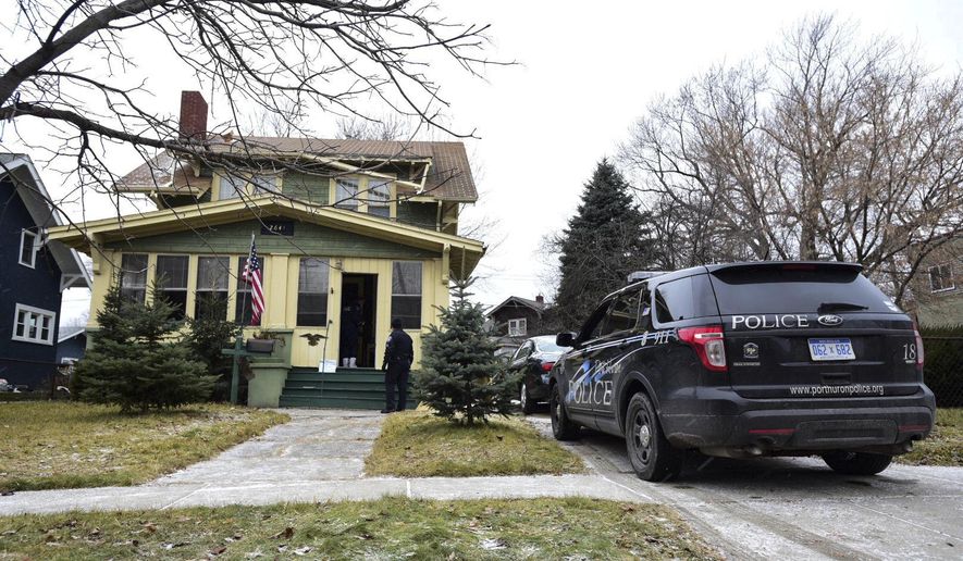 Authorities are shown outside a home where the bodies of an elderly woman and her adult son were found in Port Huron, Mich., Wednesday, Jan. 24, 2018. Authorities say no outward signs of trauma were found on the bodies after neighbors noticed mail piling up on the porch. (Brian M. Wells/Port Huron Times Herald via AP)