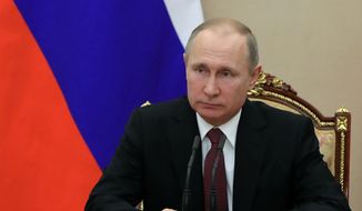In this Jan. 26, 2018, photo, Russian President Vladimir Putin chairs a Security Council meeting in Moscow, Russia. The State Department has notified Congress that it will not impose new sanctions on Russia at this time. The State Department says it is confident that new legislation enacted last year is significantly deterring Russian defense sales. (Mikhail Klimentyev, Sputnik, Kremlin Pool Photo via AP)