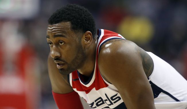 FILE - In this Jan. 10, 2018, file photo, Washington Wizards guard John Wall (2) pauses on the court during the second half of an NBA basketball game against the Utah Jazz in Washington. Wall will have arthroscopic surgery on his left knee on Wednesday and could miss much of the rest of the regular season, the Wizards announced Tuesday, Jan. 30, 2018. (AP Photo/Alex Brandon, File)