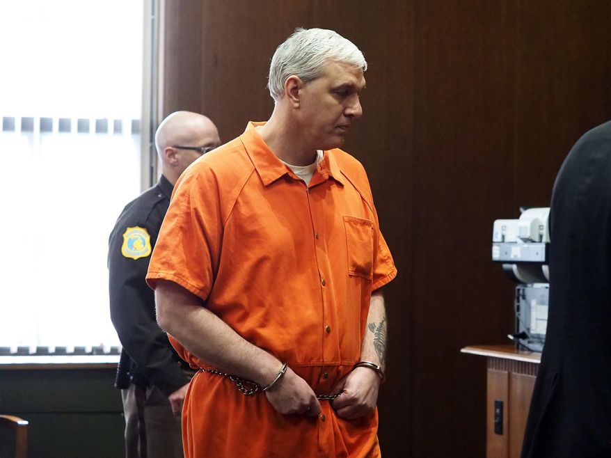 In this Monday, Jan. 29, 2018 photo, Todd Maneke, who pleaded guilty to killing his neighbor Alfred Minka in 2013, walks in a Kalamazoo, Mich., courtroom. He was sentenced to 15-20 years in prison. (Mark Bugnaski/Kalamazoo Gazette-MLive Media Group via AP)