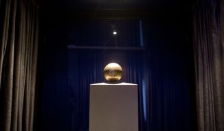 In this photo taken Thursday, Jan. 18, 2018, The ashes of scientist Nikola Tesla in a golden ball urn inside the Tesla Museum in Belgrade, Serbia.  Visitors to the Tesla Museum are treated to a flashy presentation of Nikola Tesla’s technology, as well as a huge array of the visionary scientist’s clothes, hundreds of instruments, and even his ashes. (AP Photo/Marko Drobnjakovic)