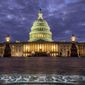 In this Jan. 21, 2018, file photo, lights shine inside the U.S. Capitol Building as night falls in Washington. (AP Photo/J. David Ake, File)
