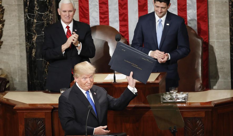 President Donald Trump holds up copies of his speech before the State of the Union address to a joint session of Congress on Capitol Hill in Washington, Tuesday, Jan. 30, 2018. (AP Photo/Pablo Martinez Monsivais)