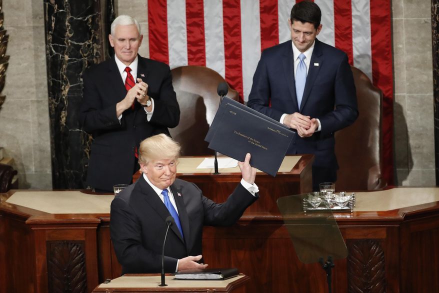 President Donald Trump holds up copies of his speech before the State of the Union address to a joint session of Congress on Capitol Hill in Washington, Tuesday, Jan. 30, 2018. (AP Photo/Pablo Martinez Monsivais)