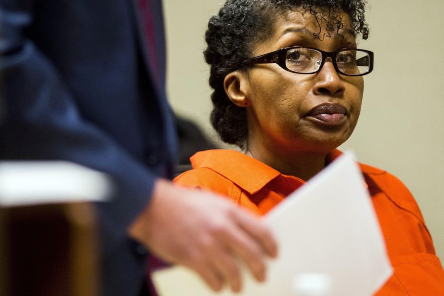 Jacquelyne Faye Tyson listens to witnesses testify during Tyson's preliminary exam on Wednesday, Jan. 31, 2018, in Genesee District Court in Flint, Mich. Tyson is accused of walking into the leasing office at Grand Oaks Apartments in Grand Blanc and shooting the two women. (Jake May/The Flint Journal-MLive.com via AP)