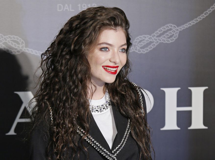 FILE - In this Nov. 18, 2014, file photo, singer Lorde poses for photographers during an promotional event in Hong Kong. An Israeli legal rights group said Wednesday, Jan. 31, 2018, it is suing two New Zealanders it credits with convincing the pop singer Lorde to cancel her performance in Israel. (AP Photo/Vincent Yu, File)