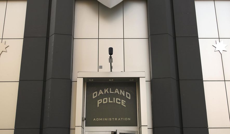 Women enter the Oakland Police building on Wednesday, Jan. 31, 2018, in Oakland, Calif. Officials say a Northern California police department dogged by a sexual misconduct scandal has spent $6 million on a court-ordered computer program to track officer conduct that is not working properly. The court-appointed monitor of the Oakland Police Department told a federal judge earlier this month that the computer program is plagued by cost overruns, bugs and data-collection errors. (AP Photo/Ben Margot)