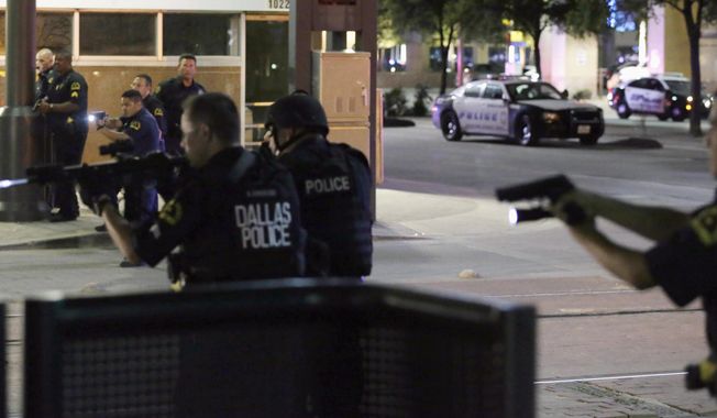 FILE - In this July 7, 2016, file photo, Dallas police move to detain a driver after several police officers were shot in downtown Dallas when a sniper opened fire at a Black Lives Matter protest. A grand jury on Wednesday, Jan. 31, 2018, declined to bring charges against Dallas police officers responsible for the death of the sniper. (AP Photo/LM Otero, File)
