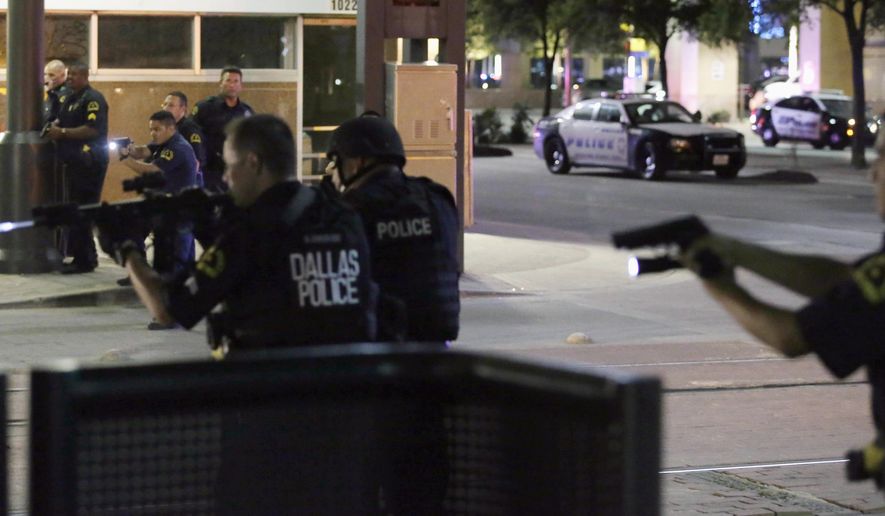 FILE - In this July 7, 2016, file photo, Dallas police move to detain a driver after several police officers were shot in downtown Dallas when a sniper opened fire at a Black Lives Matter protest. A grand jury on Wednesday, Jan. 31, 2018, declined to bring charges against Dallas police officers responsible for the death of the sniper. (AP Photo/LM Otero, File)