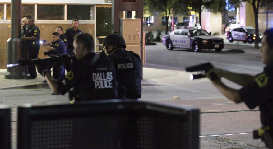 FILE - In this July 7, 2016, file photo, Dallas police move to detain a driver after several police officers were shot in downtown Dallas when a sniper opened fire at a Black Lives Matter protest. A grand jury on Wednesday, Jan. 31, 2018, declined to bring charges against Dallas police officers responsible for the death of the sniper. (AP Photo/LM Otero, File)