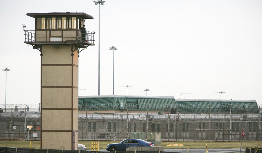 FILE - In this Feb. 1, 2017, file photo, a prison guard stands on a tower during a hostage situation at James T. Vaughn Correctional Center in Smyrna, Del. An independent review ordered by Delaware Gov. John Carney after the riot at Vaughn Correctional Center includes scores of recommendations for reforms. But officials say many of those reforms depend on adequate staffing, which remains an elusive goal. (Suchat Pederson/The News Journal via AP)