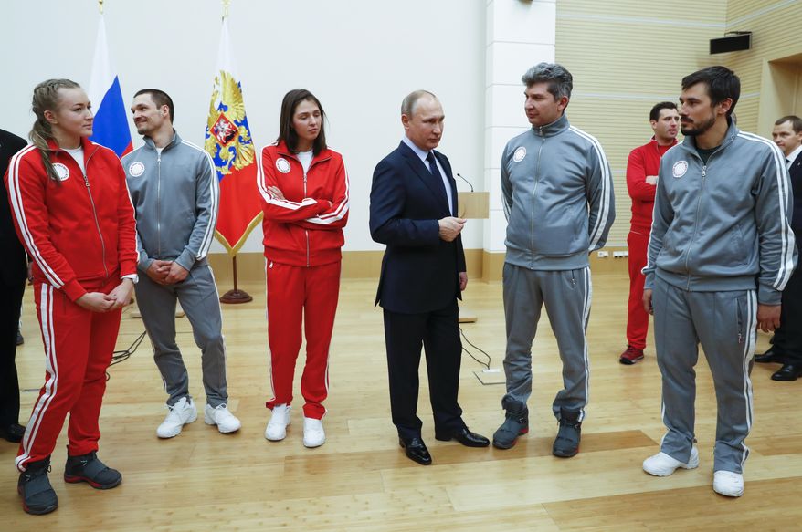 Russian President Vladimir Putin, center, poses for a photo with Russian athletes who will take part in the upcoming 2018 Pyeongchang Winter Olympic Games in South Korea, at the Novo-Ogaryovo residence outside in Moscow, Russia, Wednesday, Jan. 31, 2018. As punishment for what it deemed a doping scheme during the 2014 Sochi Olympics, the International Olympic Committee has invited 169 Russians to compete under a neutral flag using the name &amp;quot;Olympic Athletes from Russia.&amp;quot; (Grigory Dukor/Pool Photo via AP)