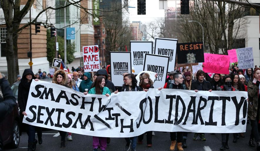 People march in support of female empowerment and women&#x27;s rights Saturday, Jan. 20, 2018, in Portland, Ore. Participants in the #MeToo March gathered at Pioneer Courthouse Square. Associated Press photo