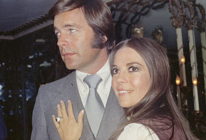 Actor Robert Wagner and former wife Natalie Wood, on board the Queen Elizabeth II in April 1972, after a hectic storm at sea, where they announced that they would remarry. (AP Photo/Steve Wood)