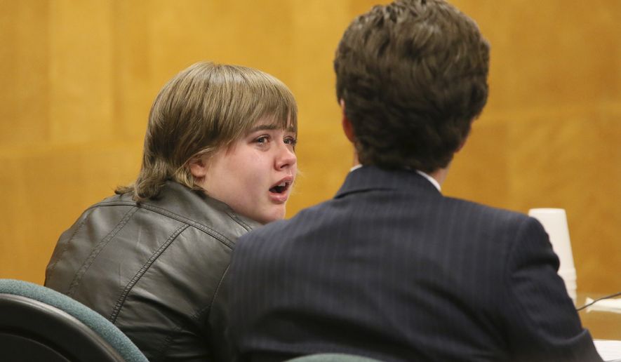 FILE - In this Oct. 5, 2017 file photo, Morgan Geyser, left, looks to her attorney Anthony Cotton as she appears in a in a Waukesha County Courtroom in Waukesha, Wis. Geyser one of two Wisconsin girls who tried to kill a classmate to win favor with fictional horror character Slender Man is being sentenced Thursday, Feb. 1, 2018, for her role in the attack. (Michael Sears /Milwaukee Journal-Sentinel via AP)