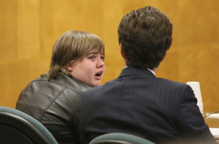 FILE - In this Oct. 5, 2017 file photo, Morgan Geyser, left, looks to her attorney Anthony Cotton as she appears in a in a Waukesha County Courtroom in Waukesha, Wis. Geyser one of two Wisconsin girls who tried to kill a classmate to win favor with fictional horror character Slender Man is being sentenced Thursday, Feb. 1, 2018, for her role in the attack. (Michael Sears /Milwaukee Journal-Sentinel via AP)