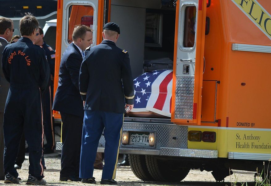In a July 10, 2015 photo, pallbearers prepare to remove Patrick Mahany's casket from a Flight for Life ambulance following a brief processional at the memorial service. Mahany was killed in a 2015 helicopter crash in Frisco, Colo. which also critically injured flight nurse David Repsher. Repsher’s lawyers said Thursday, Feb. 1, 2018, that the helicopter’s manufacturer and operator have agreed to pay Repsher a $100 million settlement. (Ben Trollinger/Summit Daily News via AP)