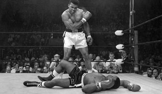 FILE - In this May 25, 1965, file photo, Muhammad Ali stands over Sonny Liston after knocking Liston down during their&#39; heavyweight championship bout in Lewiston, Maine. (AP Photo/John Rooney, File)